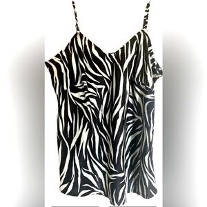 Zebra print camisole. Features adjustable straps. New with tags. Size Small